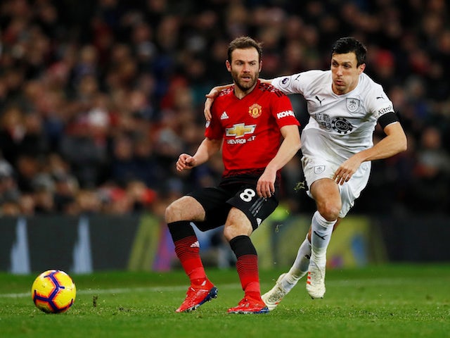 Manchester United midfielder Juan Mata tangles with Burnley midfielder Jack Cork at Old Trafford on January 29, 2019.