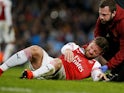 Arsenal defender Shkodran Mustafi grimaces in pain during his side's Premier League clash with Manchester City on February 3, 2019