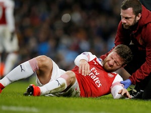 Arsenal defender Shkodran Mustafi grimaces in pain during his side's Premier League clash with Manchester City on February 3, 2019