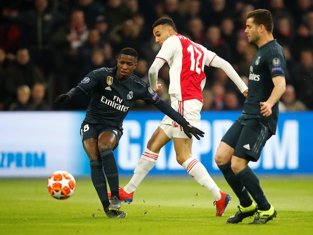 Ajax's Noussair Mazraoui in action with Real Madrid pair Vinicius Junior and Nacho in the Champions League on February 13, 2019