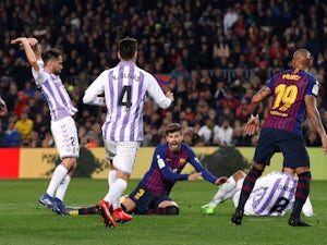 Barcelona's Gerard Pique is brought down in the box by Real Valladolid's Michel in the sides' La Liga clash on February 16, 2019