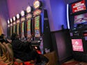 A punter playing a slot machine at a casino.