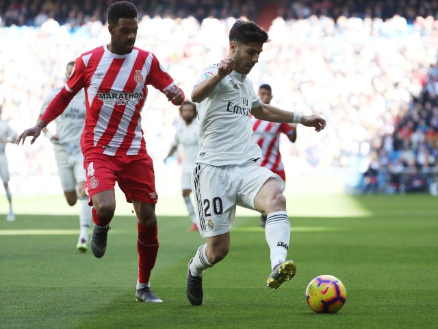 Real Madrid's Marco Asensio attempts to keep the ball against Girona in La Liga on February 17, 2019.
