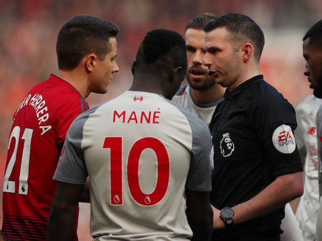Manchester United's Ander Herrera argues with referee Michael Oliver during the Premier League match against Liverpool on February 24, 2019.