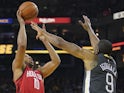 Houston Rockets guard Eric Gordon (10) shoots the basketball against Golden State Warriors guard Andre Iguodala (9) during the second quarter at Oracle Arena on February 24, 2019