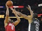 Houston Rockets guard Eric Gordon (10) shoots the basketball against Golden State Warriors guard Andre Iguodala (9) during the second quarter at Oracle Arena on February 24, 2019