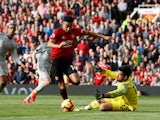 Liverpool goalkeeper Alisson Becker saves from Manchester United's Jesse Lingard in the Premier League on February 24, 2019.