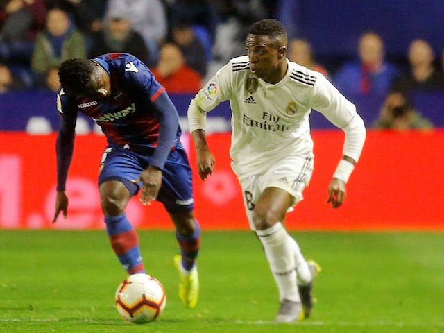 Real Madrid's Vinicius Junior in action with Levante's Moses Simon in La Liga on February 24, 2019
