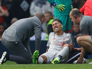 Liverpool's Roberto Firmino goes down injured during the Premier League match with Manchester United on February 24, 2019.