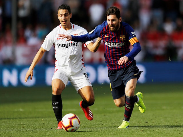 Barcelona's Lionel Messi in action with Sevilla's Wissam Ben Yedder during their La Liga clash on February 23, 2019
