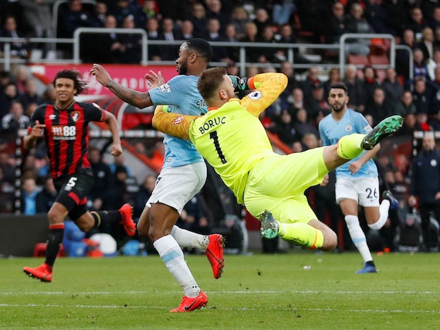 Bournemouth goalkeeper Artur Boruc challenges Manchester City attacker Raheem Sterling during their Premier League clash on March 2, 2019