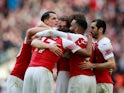 Arsenal players celebrate Aaron Ramsey's opening goal in the North London derby with Tottenham Hotspur on March 2, 2019