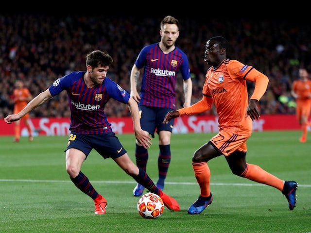 Barcelona's Sergi Roberto tangles with Lyon's Ferland Mendy in the Champions League on March 13, 2019