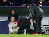 Liverpool captain Jordan Henderson receives treatment for an ankle injury against Bayern Munich on March 13, 2019