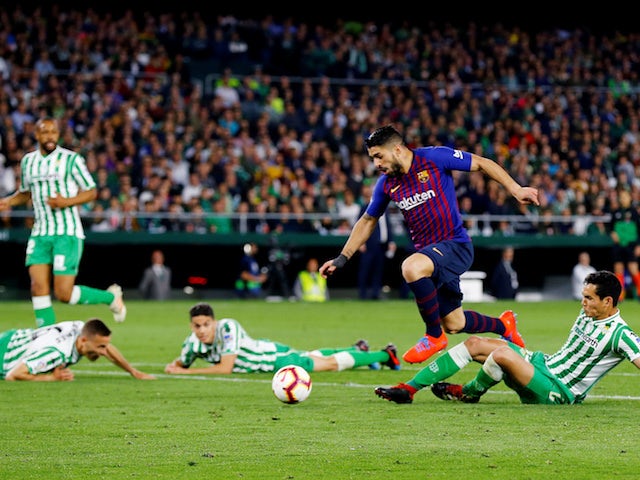 Barcelona's Luis Suarez leaves Real Betis defenders in his wake as he scores on March 17, 2019