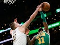 Denver Nuggets center Nikola Jokic (15) stops a shot by Boston Celtics guard Kyrie Irving (11) during the second half at TD Garden on March 19, 2019