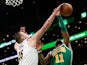 Denver Nuggets center Nikola Jokic (15) stops a shot by Boston Celtics guard Kyrie Irving (11) during the second half at TD Garden on March 19, 2019