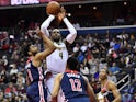 Denver Nuggets forward Paul Millsap (4) shoots as Washington Wizards guard Chasson Randle (9) and forward Jabari Parker (12) and forward Wesley Johnson (4) look on during the first half at Capital One Arena on March 22, 2019