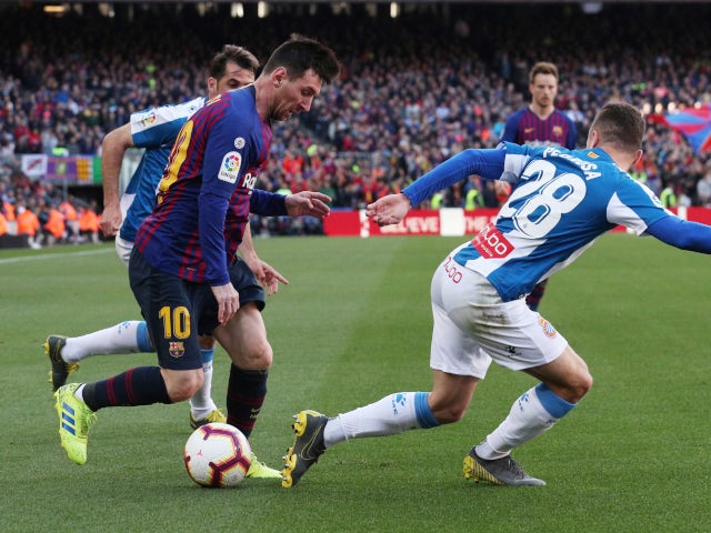 Barcelona forward Lionel Messi attempts to get away from a couple of Espanyol players at Camp Nou on March 30, 2019