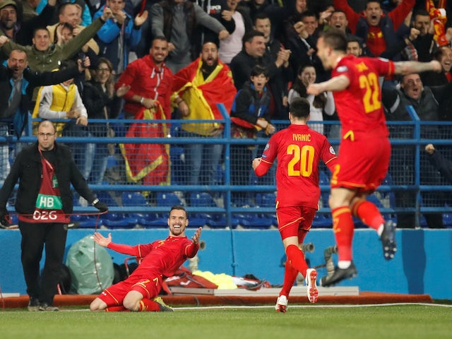Montenegro players celebrate scoring against England in their Euro 2020 qualifier on March 25, 2019