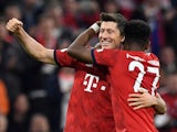 Bayern Munich's Robert Lewandowski celebrates scoring their fifth goal with David Alaba during their Bundesliga clash with Borussia Dortmund on April 6, 2019