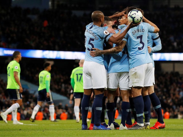Manchester City players celebrate scoring against Cardiff City on April 3, 2019