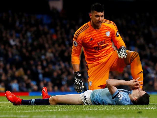Manchester City's Phil Foden reacts as Cardiff City's Neil Etheridge looks on during their Premier League clash on April 3, 2019