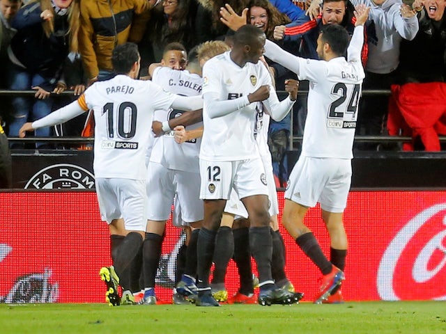 Valencia's Goncalo Guedes celebrates scoring with teammates during their game with Real Madrid on April 3, 2019