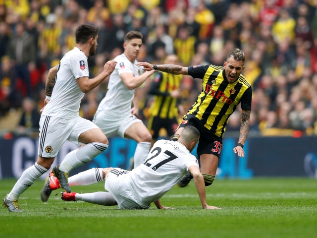 Watford's Roberto Pereyra in action with Wolverhampton Wanderers' Romain Saiss on April 7, 2019