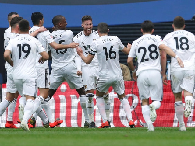 Matt Doherty is mobbed by his Wolverhampton Wanderers teammates after opening the scoring against Watford at Wembley on April 7, 2019