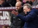 Cardiff City manager Neil Warnock speaks with match official Anthony Taylor during the Premier League clash with Burnley on April 13, 2019
