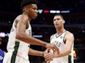Milwaukee Bucks center Brook Lopez (11) gives five to forward Giannis Antetokounmpo (34) during the second quarter against the Detroit Pistons at Little Caesars Arena on April 21, 2019