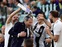 Juventus players pour water on Massimiliano Allegri after they win the Serie A title on April 20, 2019