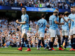 Man City go top with nervy win over Spurs