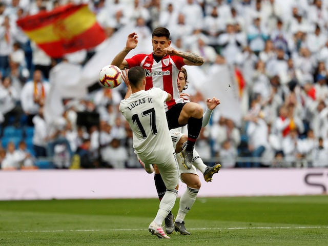 Real Madrid's Lucas Vazquez battles Athletic Bilbao's Yuri Berchiche for the ball in their La Liga clash on April 21, 2019