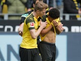Jadon Sancho is comforted by Dortmund teammates after being hit by a lighter on April 27, 2019