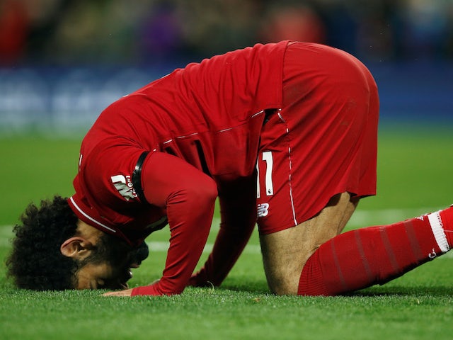 Mohamed Salah kisses the ground after making it five during the Premier League game between Liverpool and Huddersfield Town on April 26, 2019