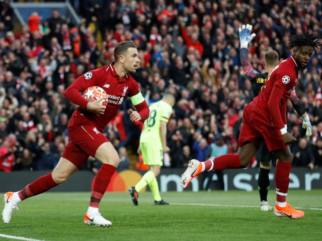 Jordan Henderson and Divock Origi after Liverpool score against Barcelona in the Champions League on May 7, 2019.