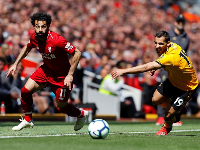 Liverpool's Mohamed Salah beats Wolverhampton Wanderers's Jonny Otto to the ball in the Premier League on May 12, 2019.