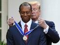 Donald Trump puts a medal around the neck of Tiger Woods on May 6, 2019