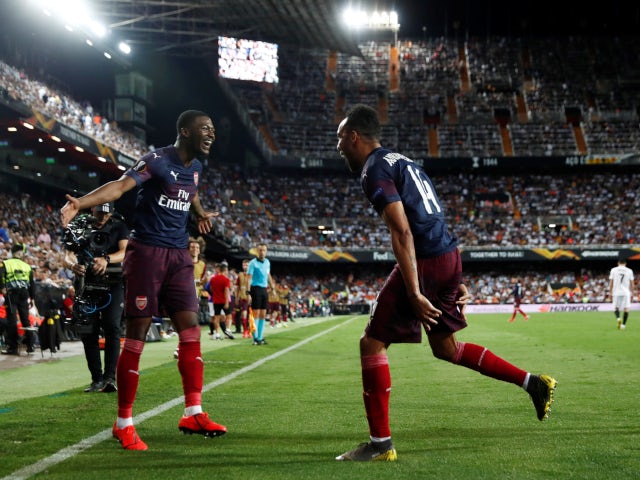 Pierre-Emerick Aubameyang celebrates with Ainsley Maitland-Niles after scoring his second goal against Valencia on May 9, 2019