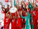Bayern Munich's Rafinha, Arjen Robben and Franck Ribery lift the trophy as they celebrate winning the Bundesliga title on May 18, 2019