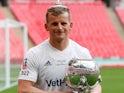 AFC Fylde joker Danny Rowe poses with the FA Trophy partly on his head on May 19, 2019