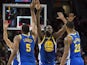 Golden State Warriors forward Draymond Green (23) gives high-fives to teammates center Kevon Looney (5) and forward Alfonzo McKinnie (28) during the second half in game three of the Western conference finals of the 2019 NBA Playoffs at Moda Center on May 