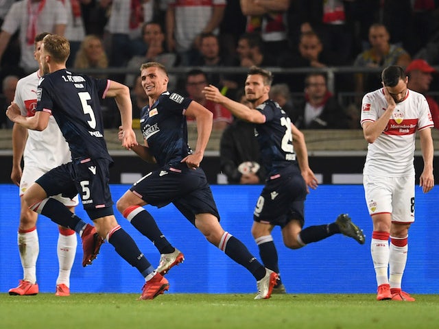 Union Berlin's Marvin Friedrich celebrates scoring their second goal with team mates as VfB Stuttgart's Gonzalo Castro looks dejected on May 23, 2019