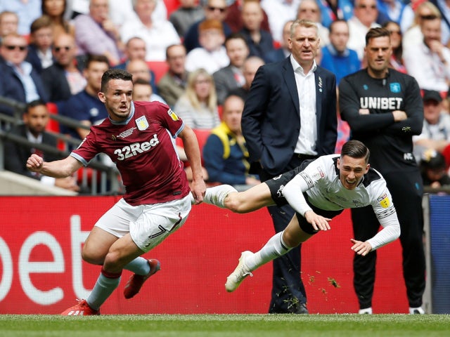 Aston Villa's John McGinn in action with Derby County's Harry Wilson as Villa boss Dean Smith looks on during the Championship playoff final on May 27, 2019