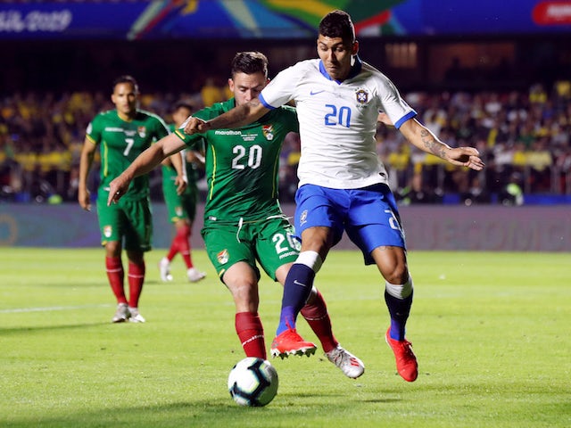 Brazil's Roberto Firmino in action with Bolivia's Fernando Saucedo in the Copa America on June 14, 2019