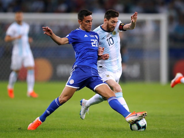 Argentina's Lionel Messi battles Paraguay's Matias Rojas for the ball in the Copa America on June 19, 2019