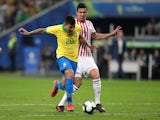 Brazil's Roberto Firmino in action with Paraguay's Fabian Balbuena in the quarter-finals of the Copa America on June 27, 2019
