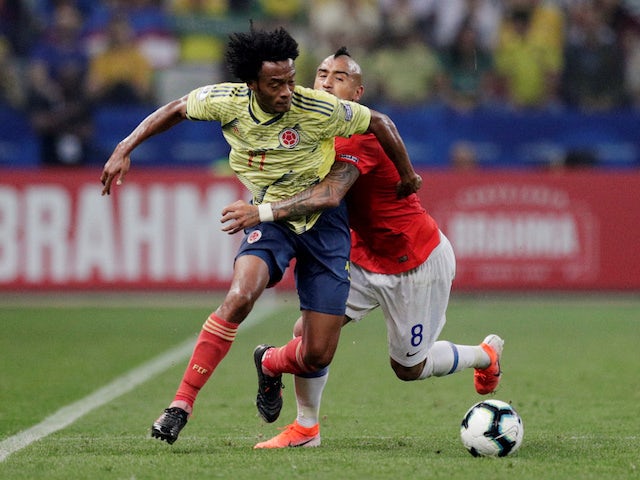 Colombia's Juan Cuadrado in action with Chile's Arturo Vidal in the Copa America quarter-finals on June 28, 2019